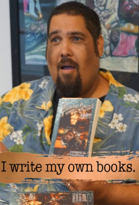 Author, Jason Henry Evans holding his book